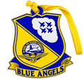A Blue Angels commemorative ornament shaped like a military crest, featuring a yellow and blue shield design with four jets in a cloud, an eagle emblem, and a yellow ribbon hanging from the top.