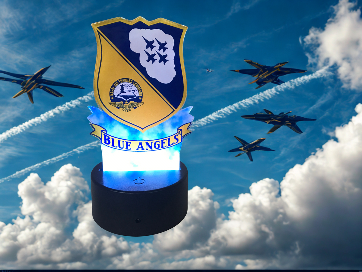 A Blue Angels themed night light featuring a shield emblem and jets, shown floating against a sky background with clouds and fighter jets.